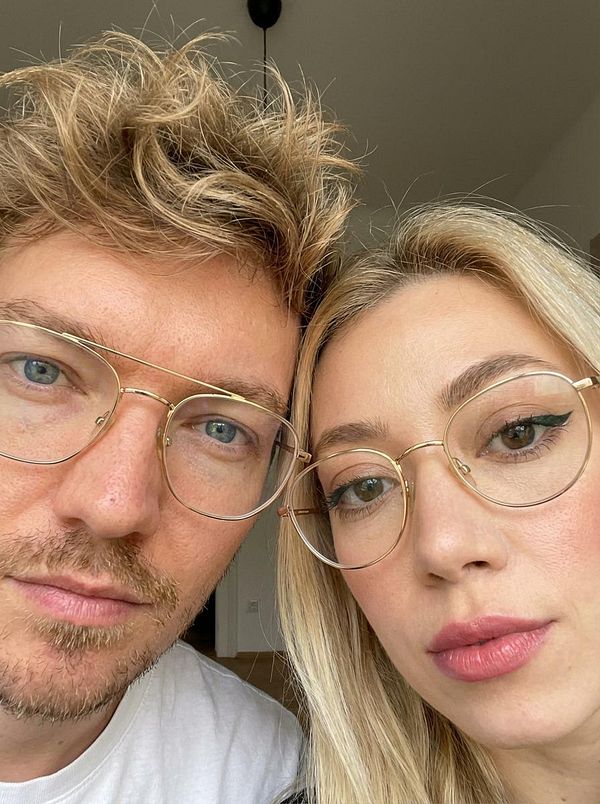 A close-up selfie of a man and a woman wearing glasses, showcasing their facial features and expressions.