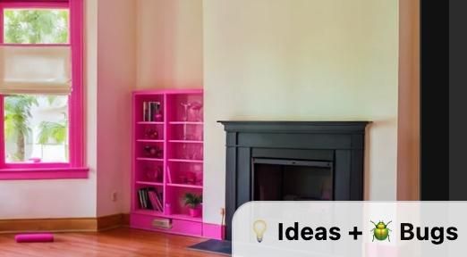 A bright and modern interior space featuring a pink bookshelf and a black fireplace.