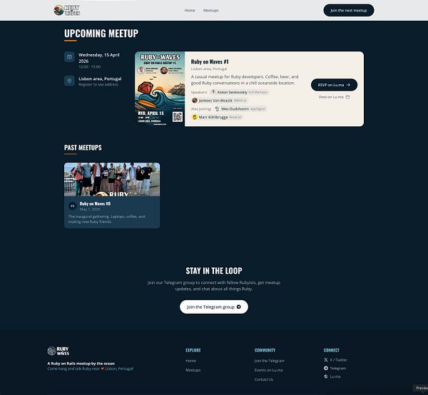 A nighttime aerial photograph of an urban coastal city with illuminated buildings and streets reflecting in the harbor water.