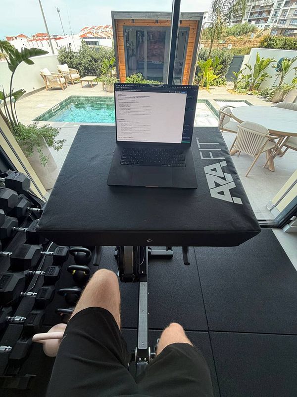A fit woman is running on a treadmill in a modern gym environment.