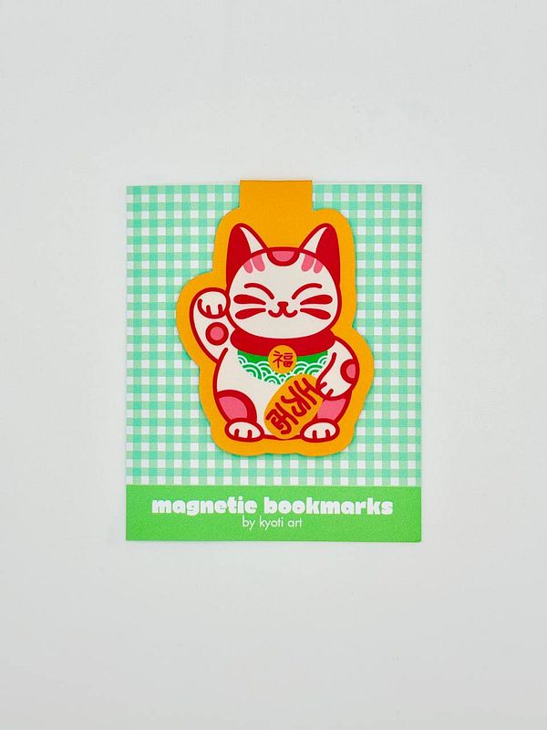A colorful magnetic bookmark featuring a cartoon cat design on a checkered background.