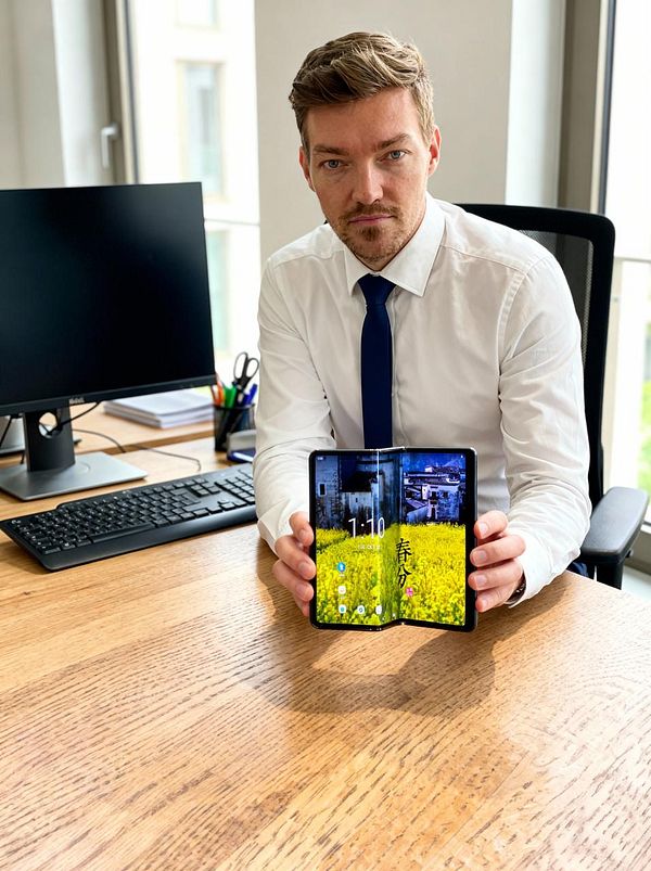 A near-photo-realistic render of a robot with blue metallic textures posing against a dark background.
