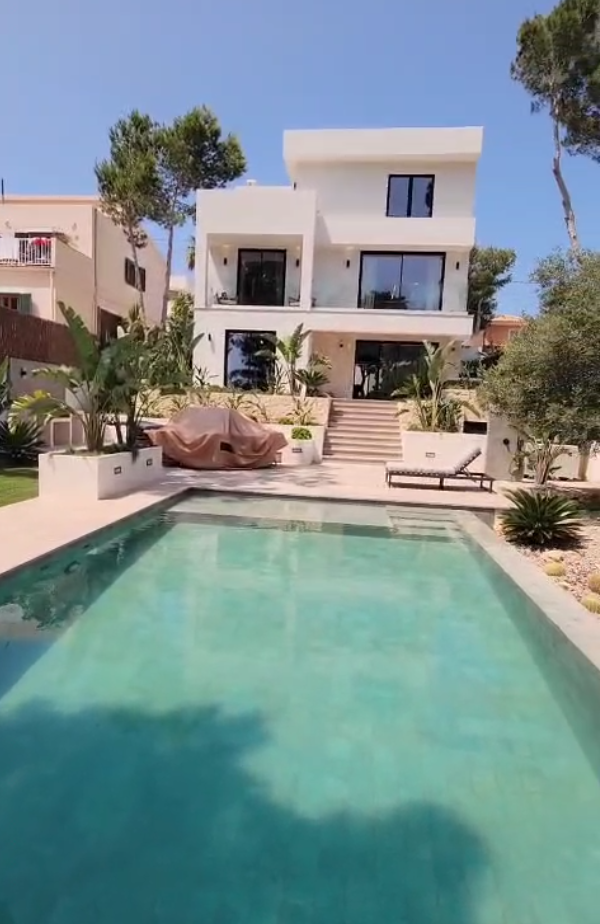 A modern villa with a swimming pool and landscaped garden.