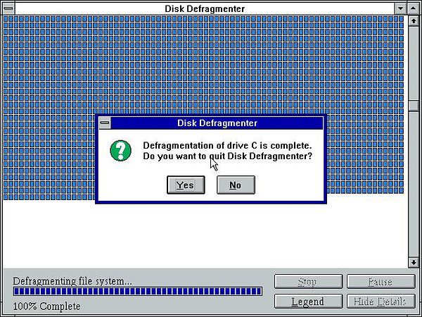 A completed disk defragmentation process on Windows 3.11 is displayed.