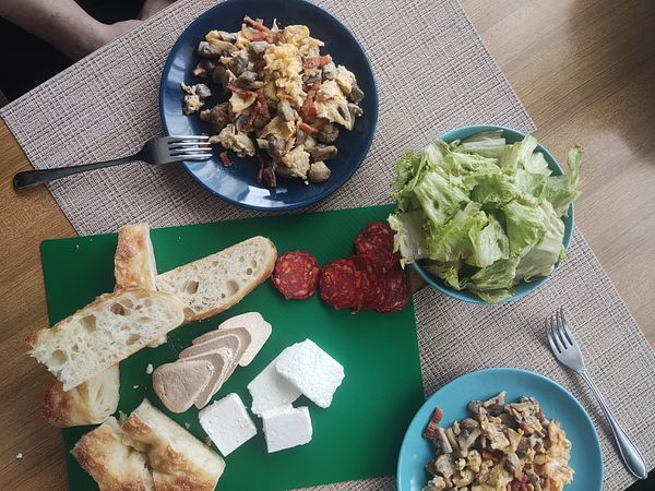 A traditional Croatian lunch featuring various dishes and ingredients.