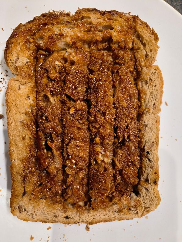 A slice of bread is creatively prepared with a spread and cut into sections for easy handling.