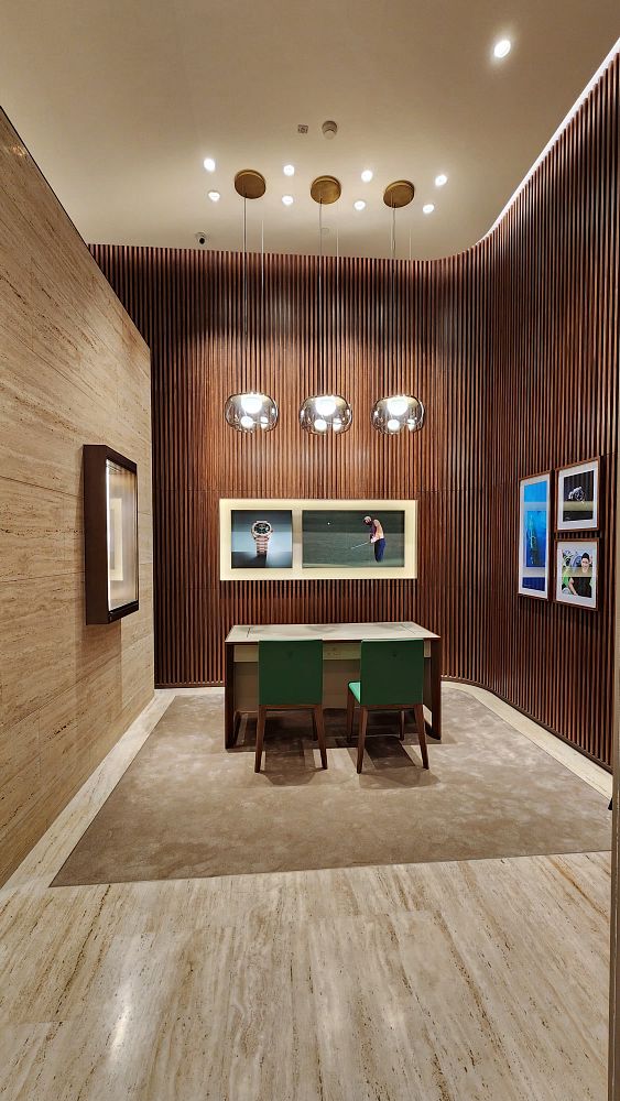 The image depicts the interior of a luxurious Rolex boutique featuring modern design elements.