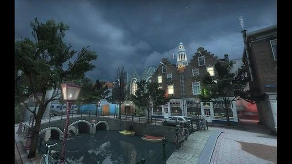 A nighttime urban scene depicting a canal with small boats, a bridge, classic Dutch-style buildings, and a tree-lined street under a cloudy sky.