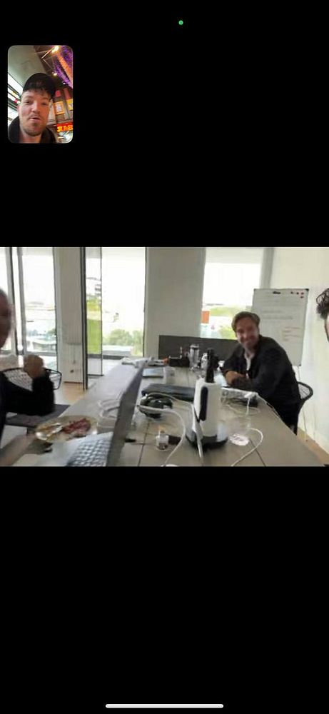 A remote coworking session is taking place with participants visible on a video call.