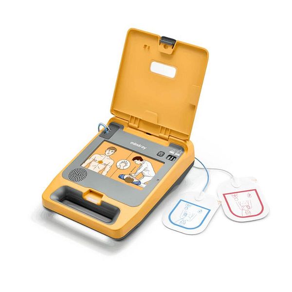 Close-up photo of a white Automated External Defibrillator (AED) device showing its screen, buttons, and handle.