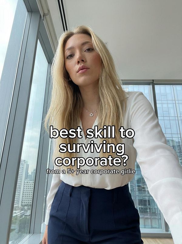 A young woman poses in a corporate setting, asking about skills for surviving in a corporate environment.