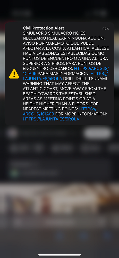 A civil protection alert message regarding a tsunami drill in South Spain.
