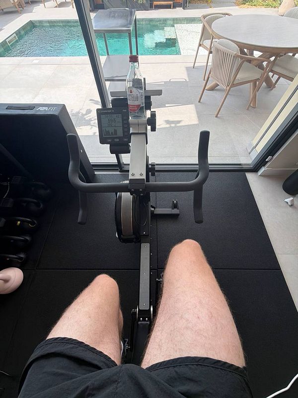 A female athlete performing a cardio workout on a treadmill in a gym setting.