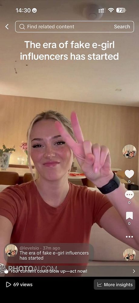 Portrait of a man with eyeglasses, wearing a red and black checkered jacket, against a dark background.