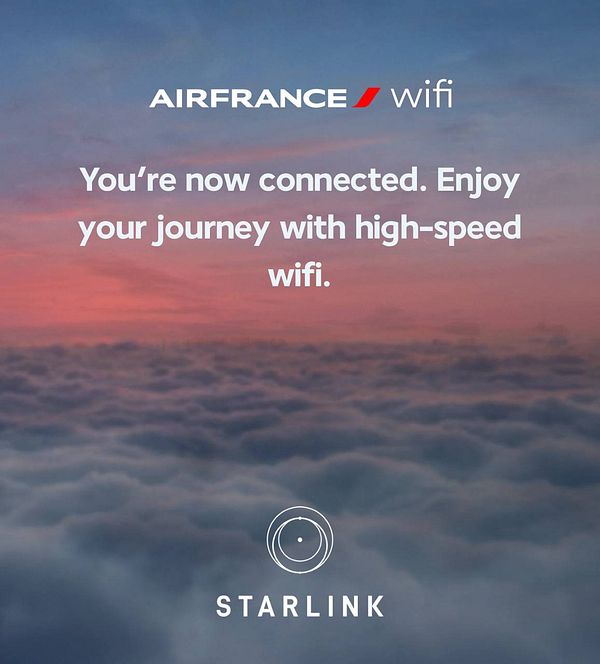 Interior view of an Air France airplane cabin highlighting the seatback screens showing Starlink internet connectivity information and the cabin's modern design.