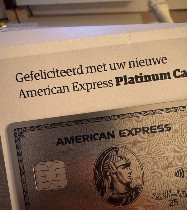 A close-up of an American Express Platinum Card alongside a congratulatory message.