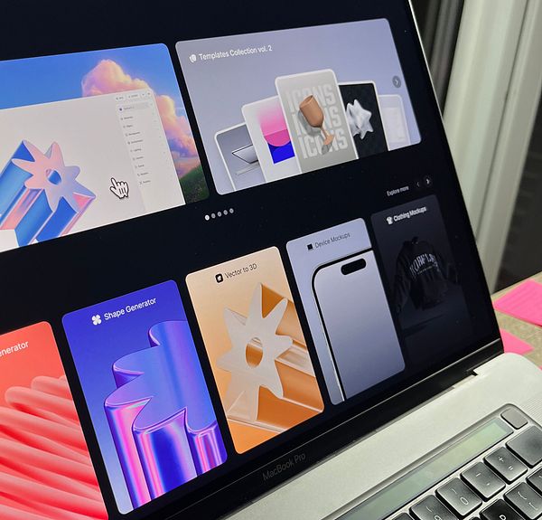 A creative workspace featuring a computer monitor displaying a digital design, surrounded by art supplies and decorative items.