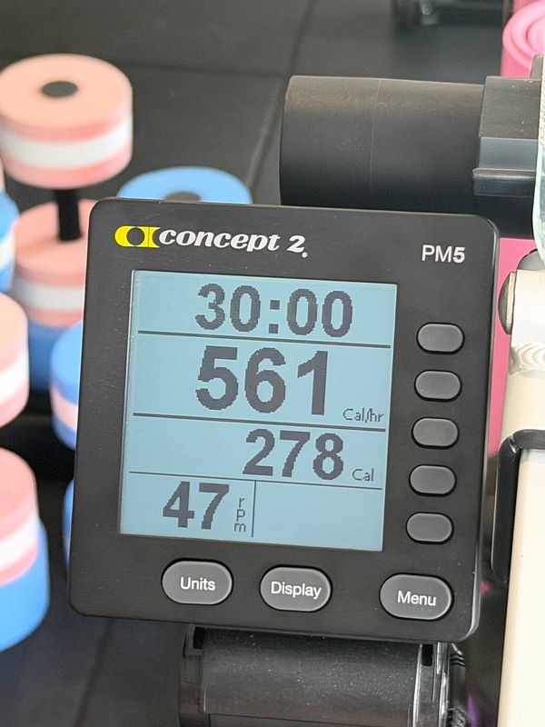 The image displays a Concept2 PM5 monitor showing workout statistics.