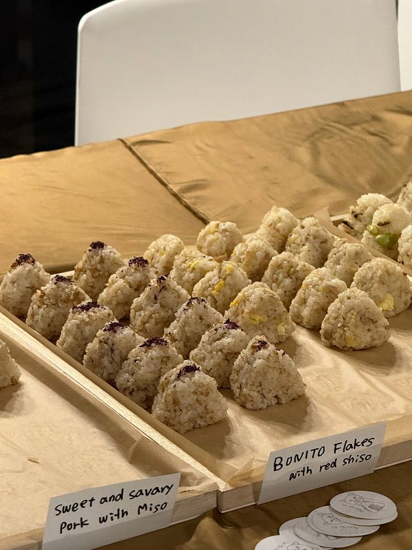 A nighttime cityscape of Paris featuring the Eiffel Tower illuminated with blue lights and the Champs-Élysées avenue.