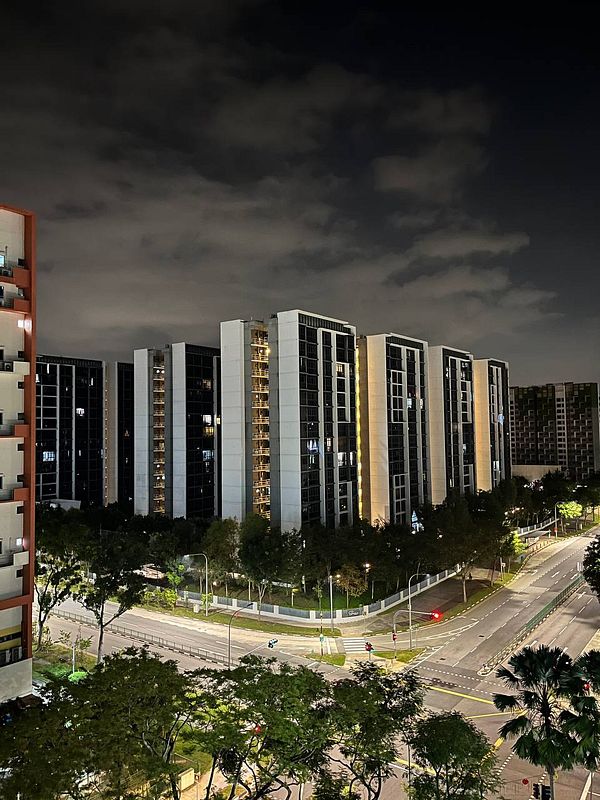 A nighttime view of modern residential buildings in Yishun, Singapore.