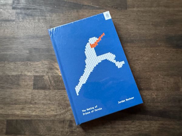 A book titled 'The Making of Prince of Persia' by Jordan Mechner is displayed on a wooden surface.