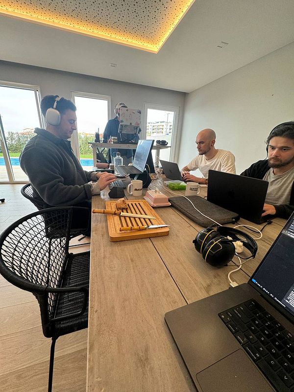 A group of three individuals working collaboratively in a modern coworking space.