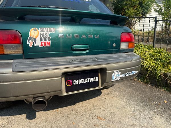 Rally car with a custom sticker on the rear side panel.
