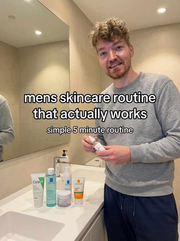 A man demonstrates a simple skincare routine in a bathroom setting.