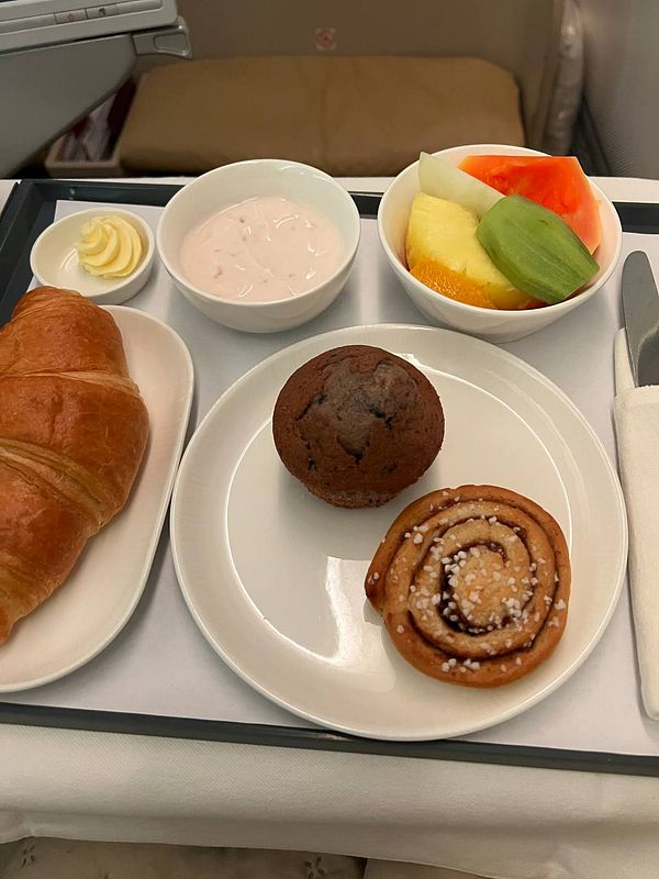 A luxurious in-flight meal featuring a variety of breakfast items.