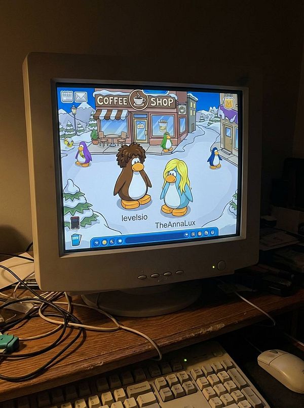 A vibrant digital illustration of multiple Club Penguin characters in a snowy landscape with a large tree and blue sky.