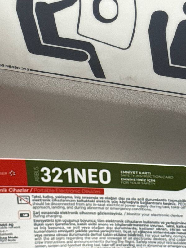 Interior photograph of a modern bedroom featuring a large bed, cozy blankets, pillows, and soft lighting.