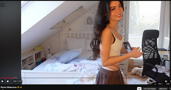 German YouTuber in a casual, modern room with headphones and a microphone, preparing to speak or record.