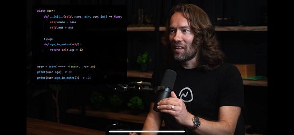 A man with long hair is discussing programming concepts while a code snippet is displayed on the screen.