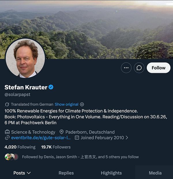 Screenshot of a tweet featuring a photo of a man in a conference room with hashtags and comments about a German professor anti-AC.