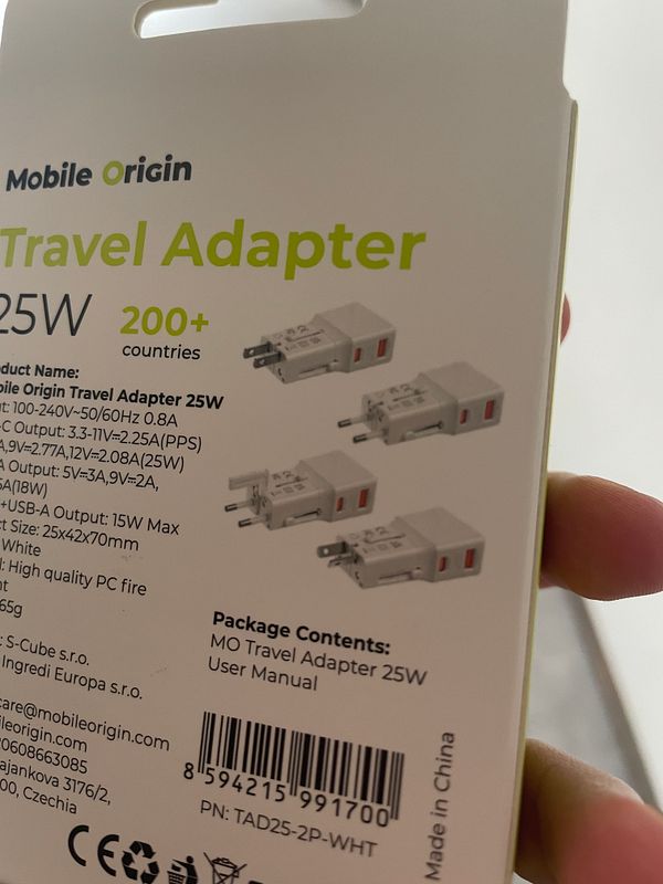 The image displays the packaging of a Mobile Origin Travel Adapter designed for international use.