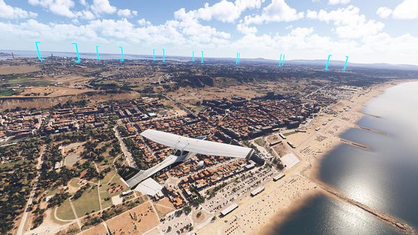 A scenic aerial view of Costa de Caparica with a small aircraft flying above the coastline.