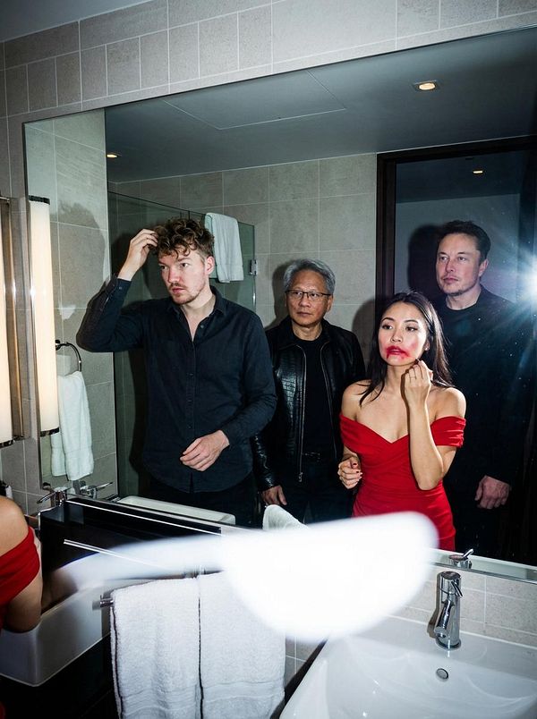 A group of four individuals is captured in a bathroom mirror selfie, showcasing a mix of casual and formal attire.