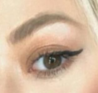 A close-up of a person's eye with makeup.