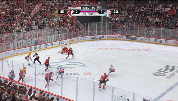 A tense moment in a hockey final match between LHC and ZSC, with the score tied at 2-2.