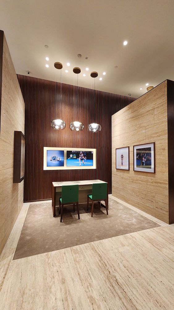The image depicts the interior of a luxurious Rolex boutique featuring a modern design.