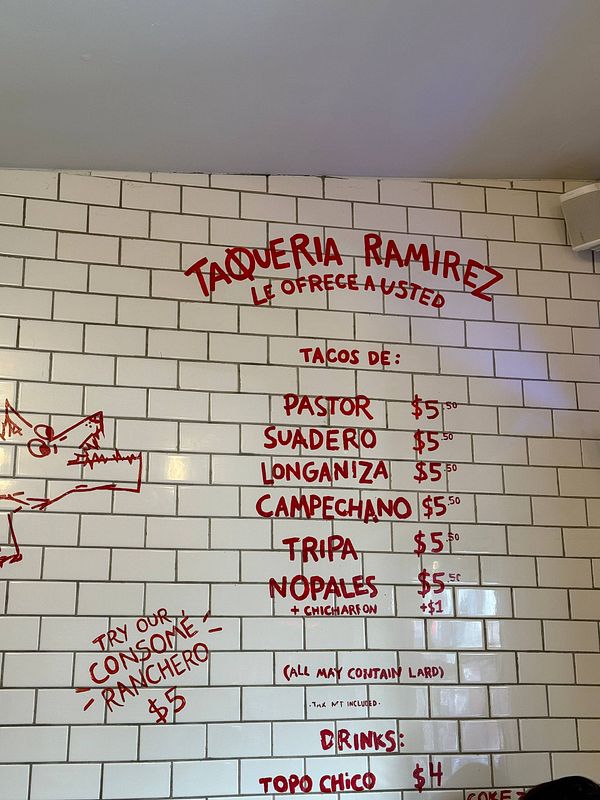 A taqueria storefront with vibrant colors and traditional Mexican decor.