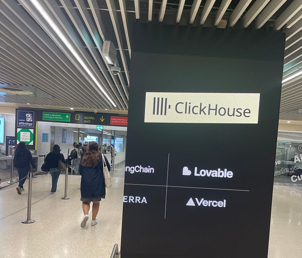 The image captures a bustling airport scene in Lisbon with a digital display featuring the ClickHouse logo and various company names.