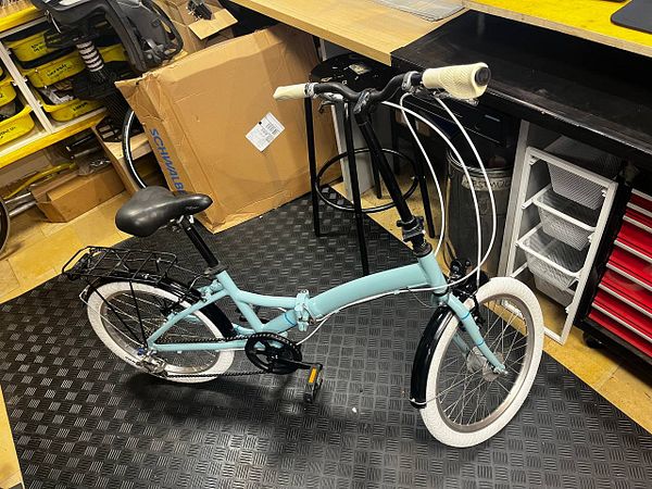 A fully restored folding bike with new components and clean detailing.