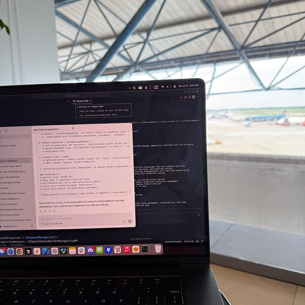 A laptop displaying coding information is positioned in front of an airport view.