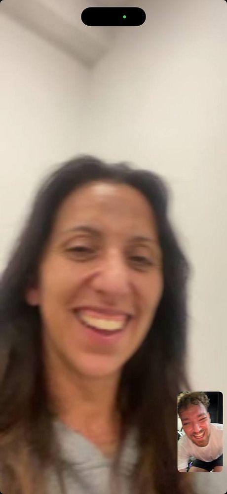 A photo shows a woman lifting weights in a gym environment equipped with fitness equipment and large windows.
