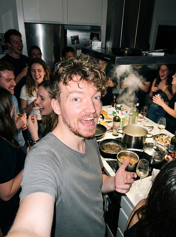 A lively kitchen party scene with a group of friends enjoying a gathering.