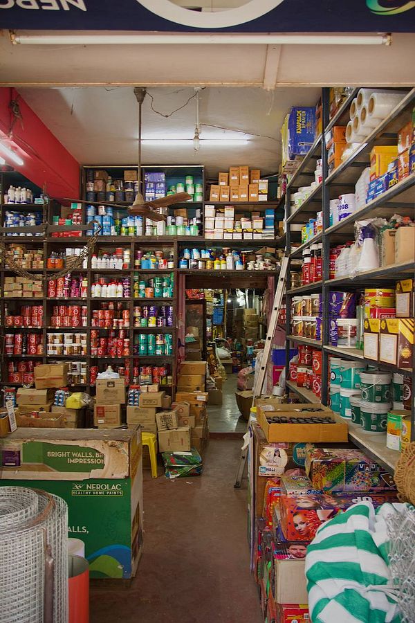 A vibrant and cluttered interior of a local shop filled with various products and boxes.