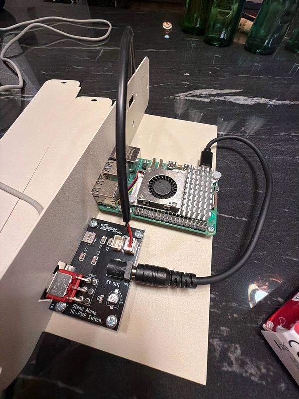 A Raspberry Pi is mounted on a retro display setup with a power switch module connected.