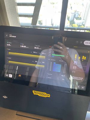 The image displays a fitness machine's touchscreen interface showing workout statistics.