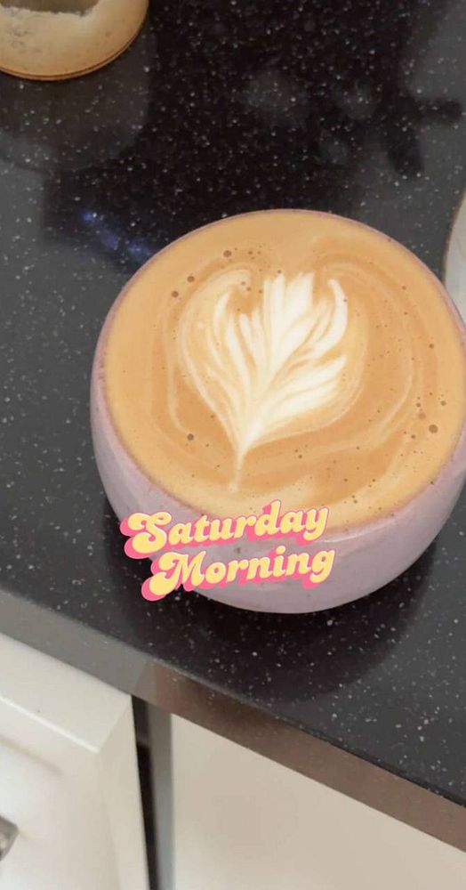 A close-up photograph of a handmade craft resembling a tulip with purple petals and a green stem.